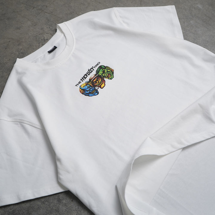 White sweatshirt with colorful graphic design on a gray surface