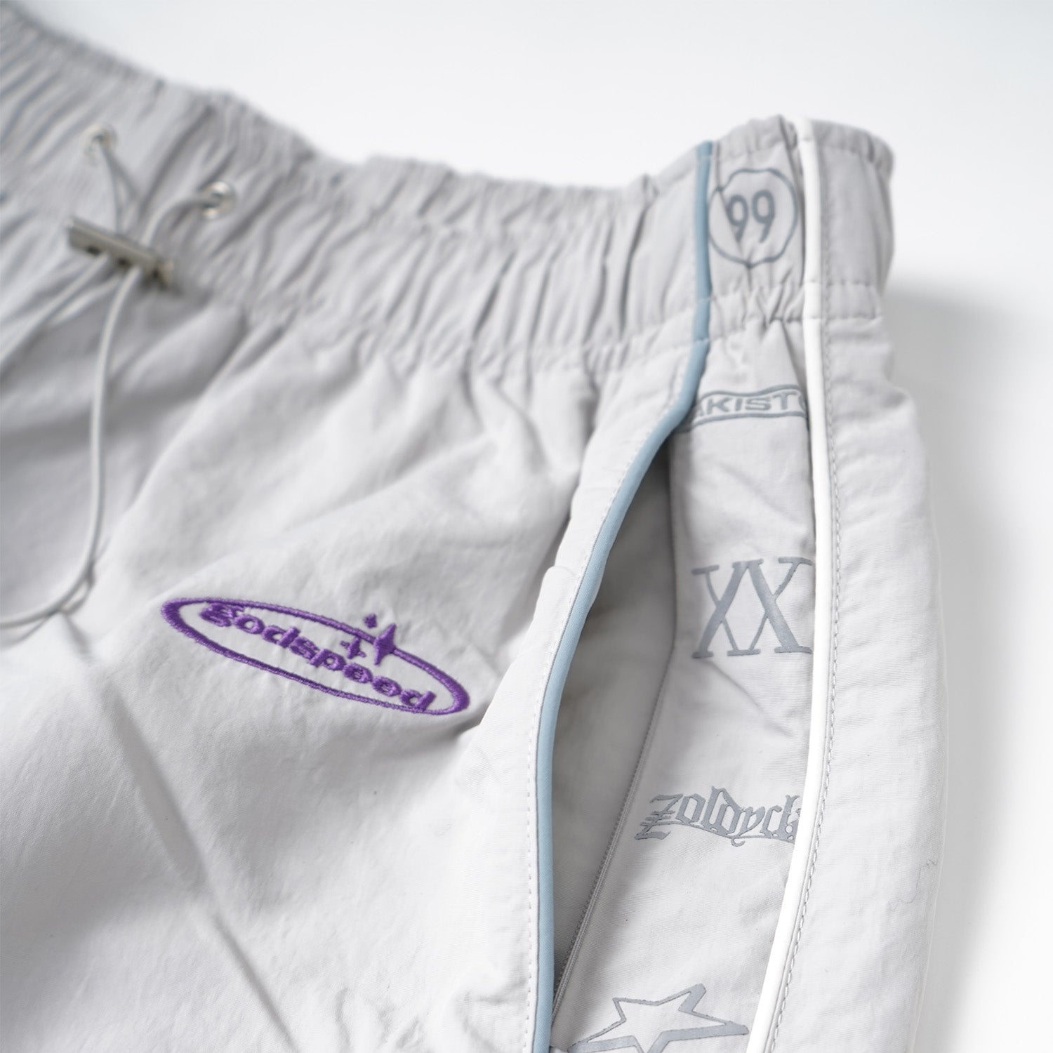 White shorts with branding on a white background