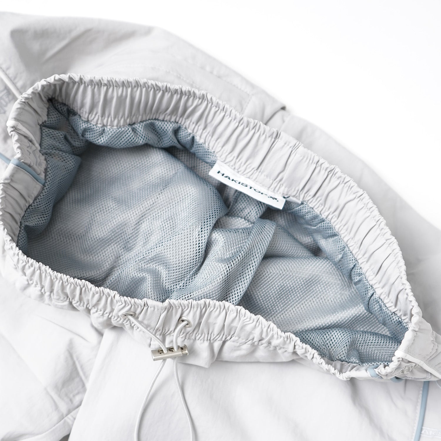 Close-up of a baby diaper with mesh backing and brand label.