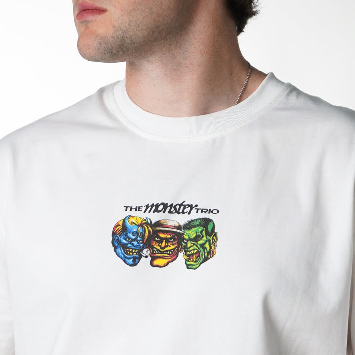 White t-shirt with colorful monster graphic and 'The Monster Trio' text on a white background