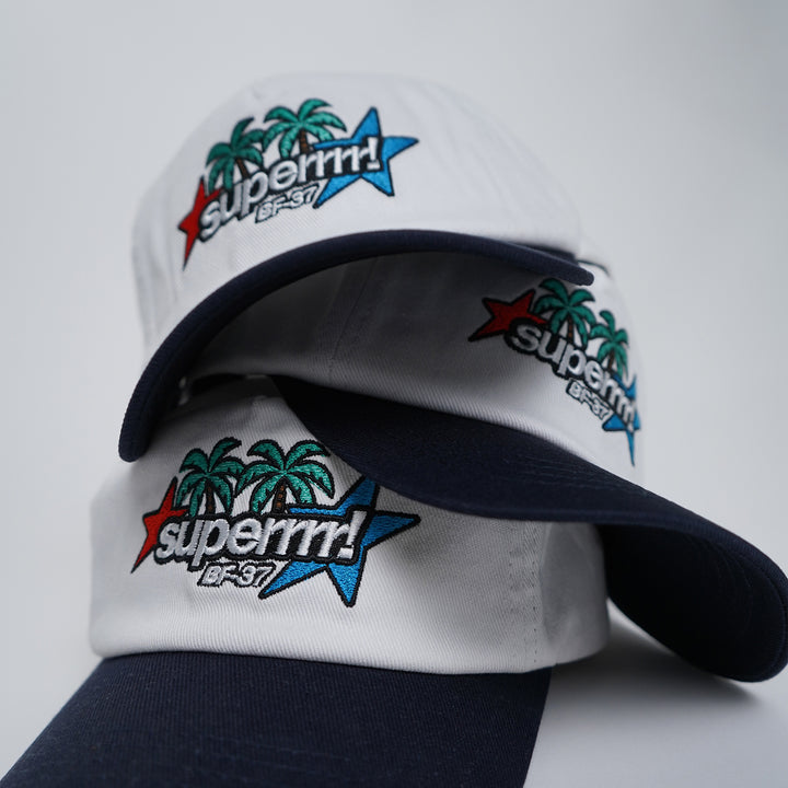 White and navy cap with colorful 'superrrrr!' branding on a light gray background