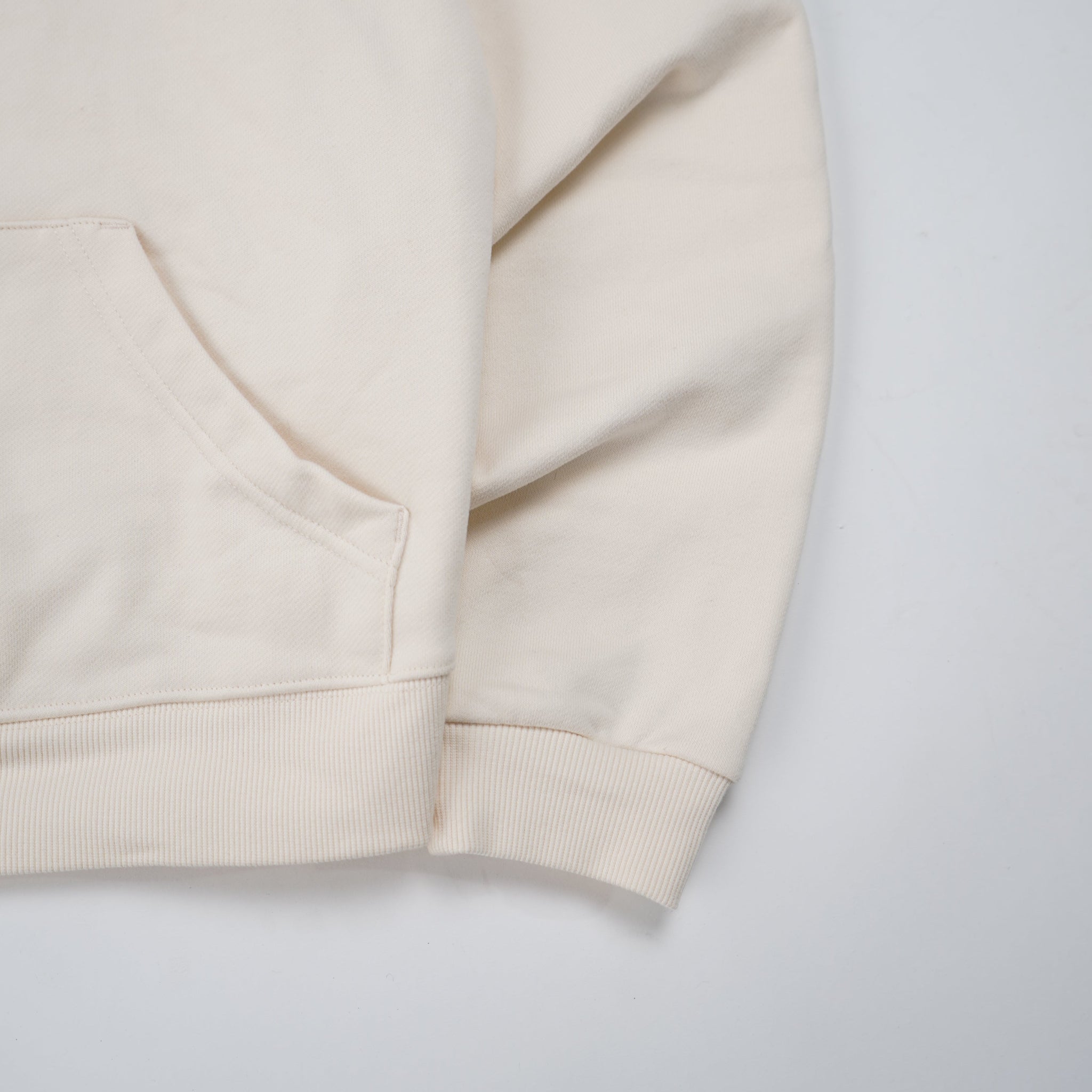 Beige shorts with a brand logo on a light gray background