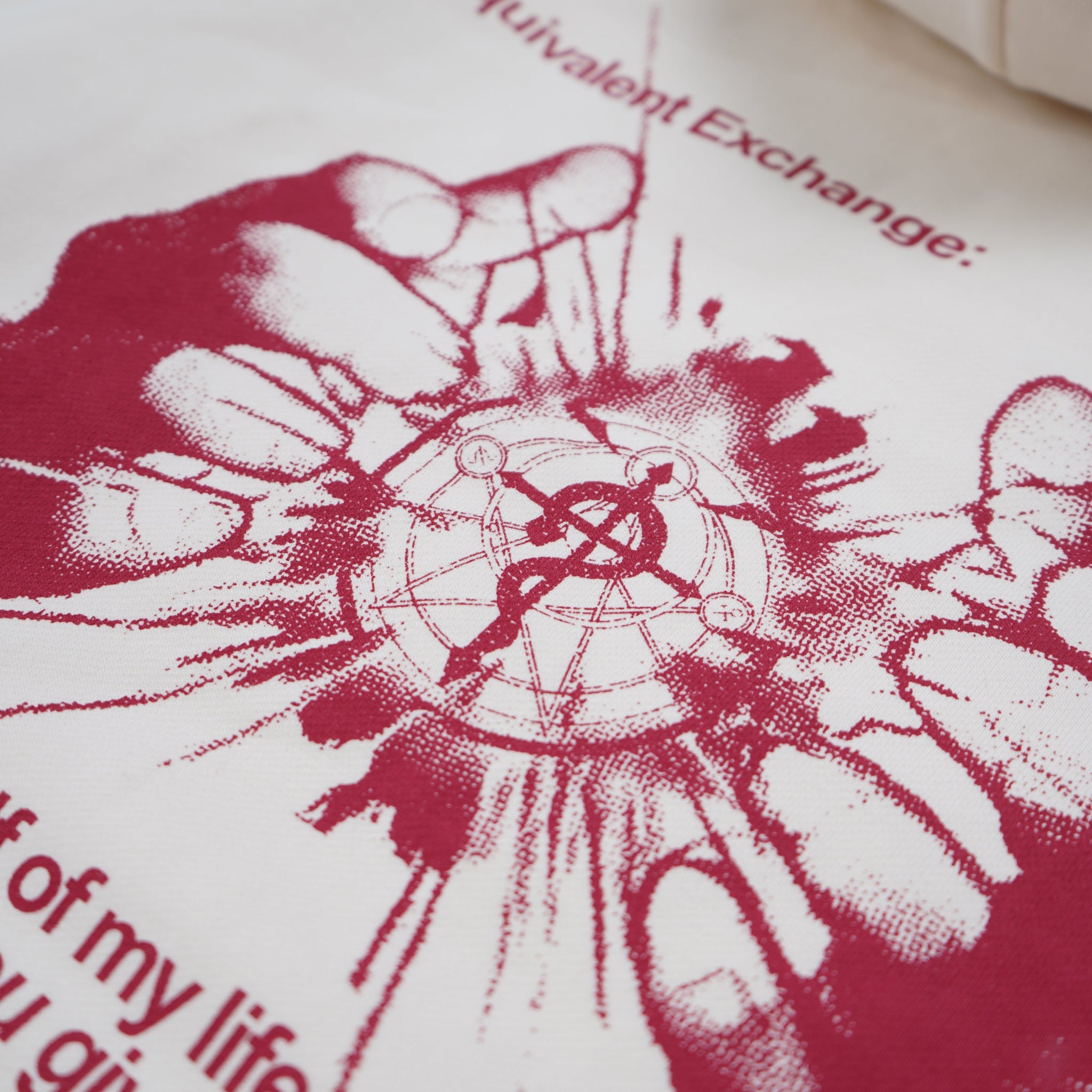 White pillow with red graphic design and text on a white background