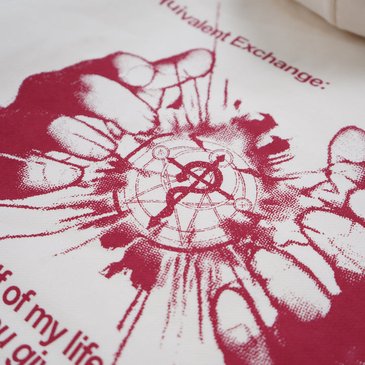 White pillow with red graphic design and text on a white background