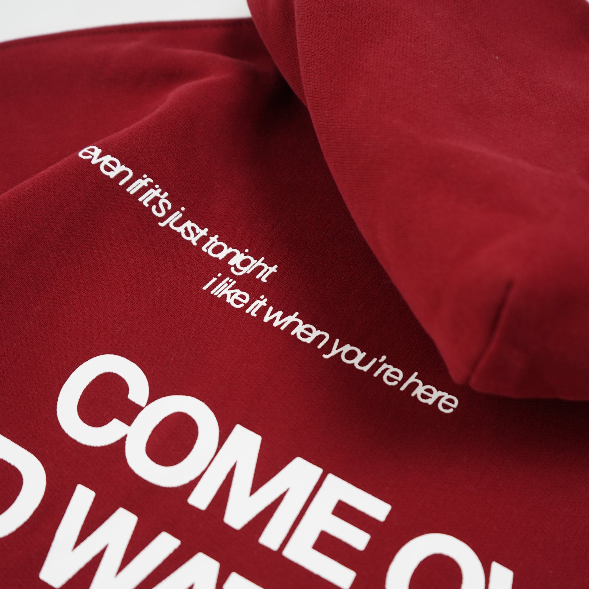 Red sweatshirt with white text on a white background