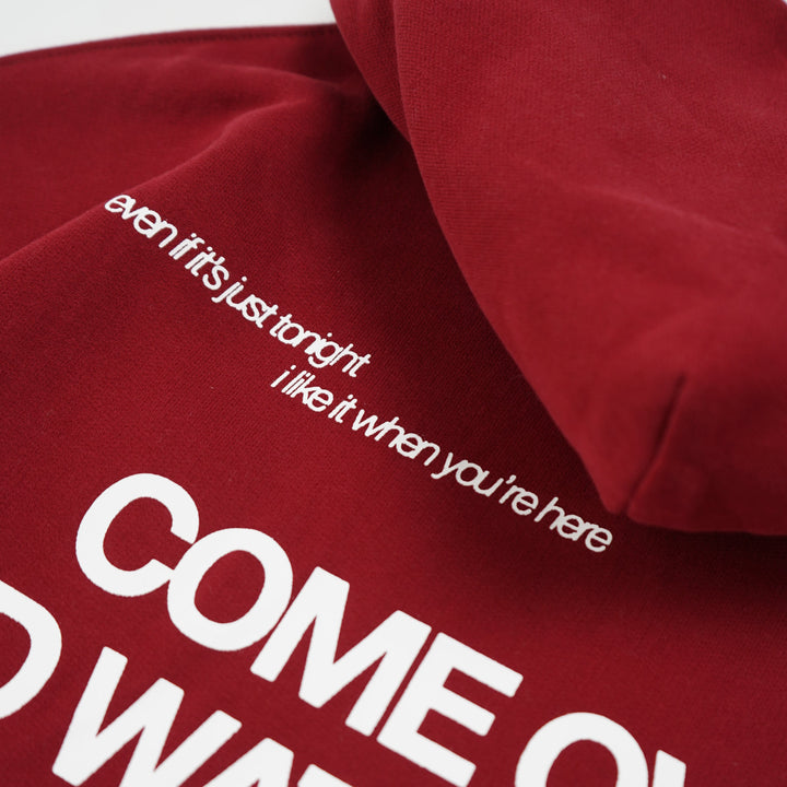 Red sweatshirt with white text on a white background